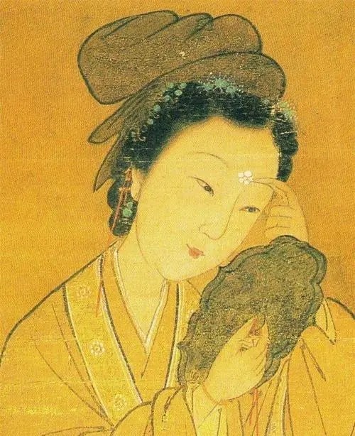 《木兰诗》中的“当窗理云鬓，对镜贴花黄”是什么意思？